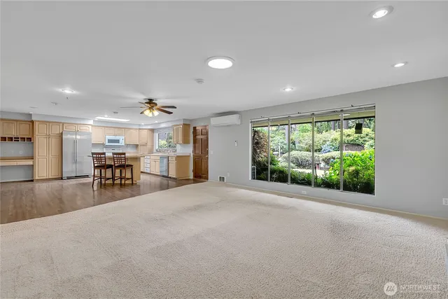 a view of a livingroom with furniture and a large window
