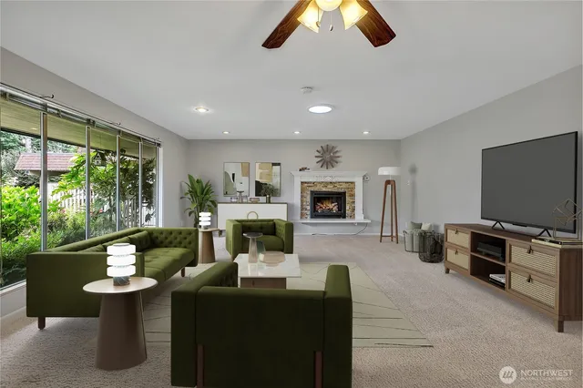 a living room with furniture a flat screen tv and a fireplace