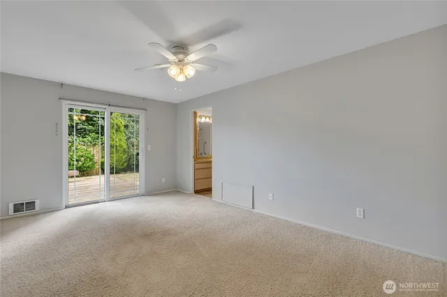a view of a livingroom with a ceiling fan and window