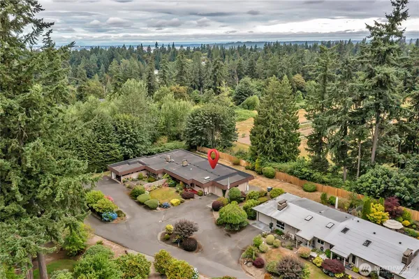 an aerial view of a house with a yard