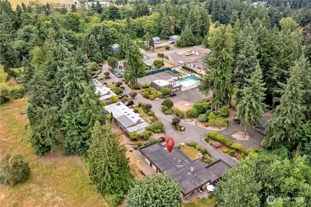an aerial view of residential houses with outdoor space