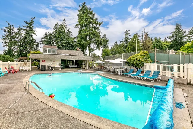 a view of a swimming pool with chairs