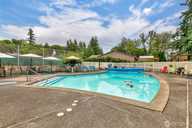 an outdoor space with swimming pool and furniture
