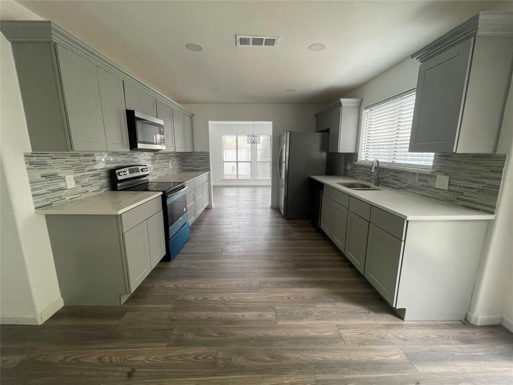 3 Ridge Drive Hickory Creek, TX 75065 - Photo 11 of 20 a large kitchen with stainless steel appliances granite countertop a stove top oven a sink dishwasher and a refrigerator