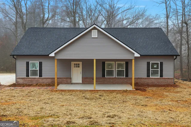 a front view of a house with a garden