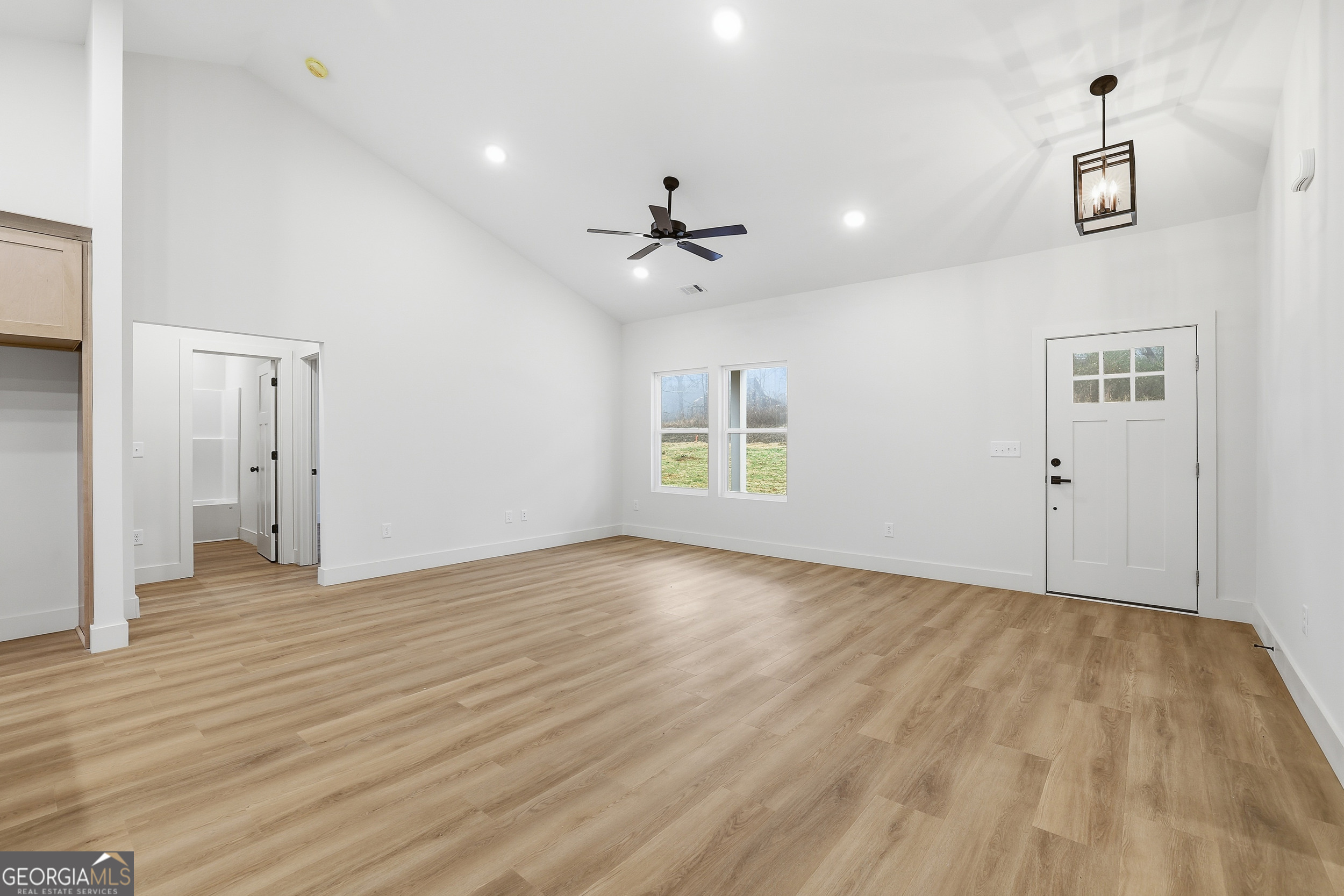 146 James Road Clarkesville, GA 30523 - Photo 14 of 25 a view of an empty room with window and wooden floor
