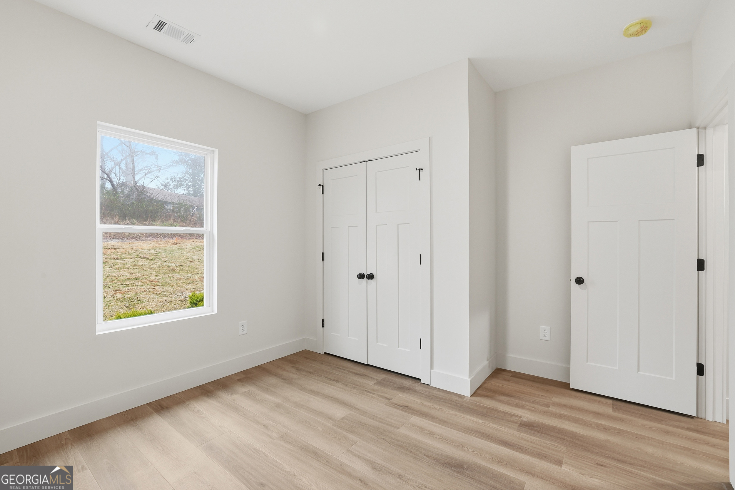 146 James Road Clarkesville, GA 30523 - Photo 18 of 25 a view of an empty room with wooden floor and a window