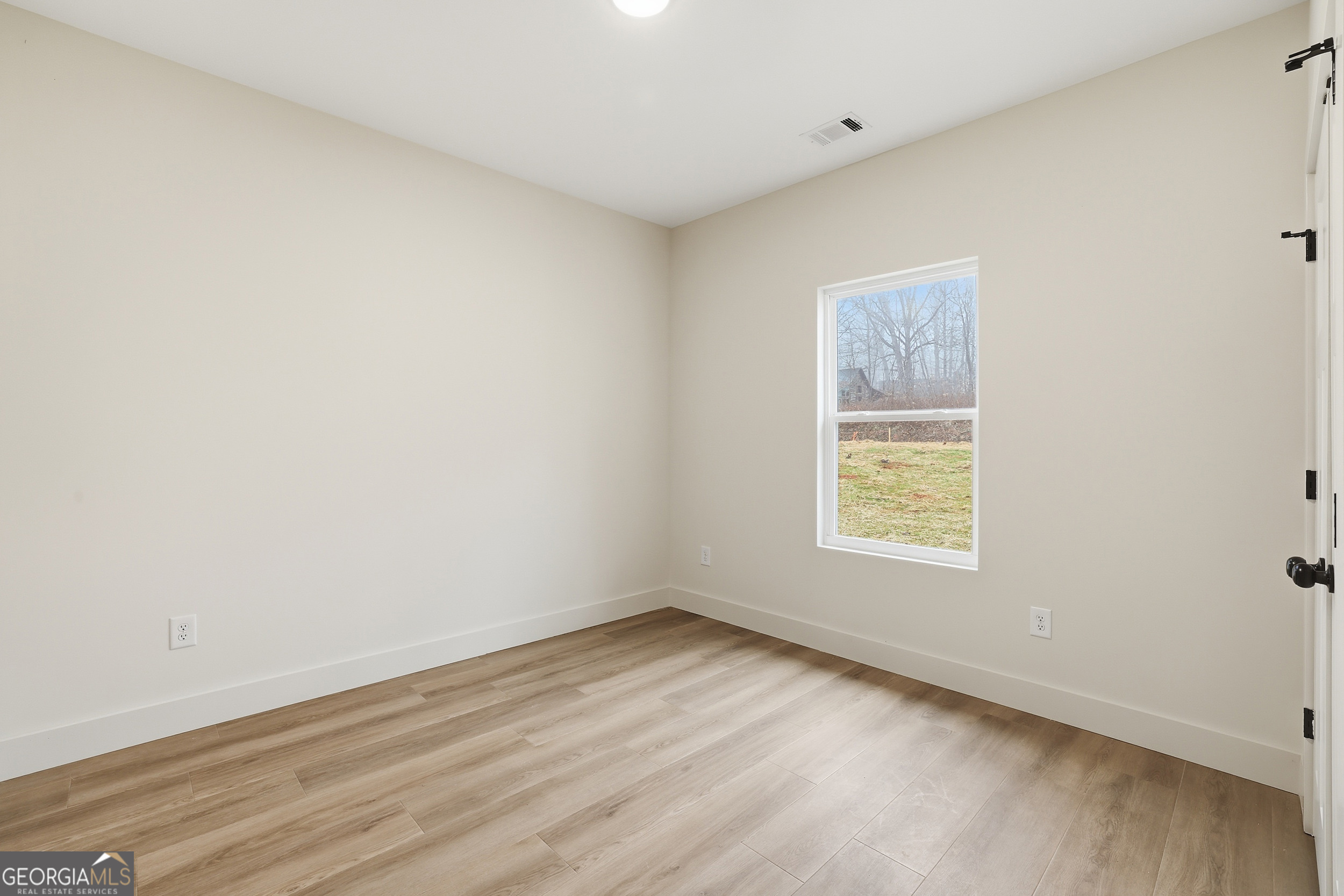 146 James Road Clarkesville, GA 30523 - Photo 19 of 25 an empty room with wooden floor and windows