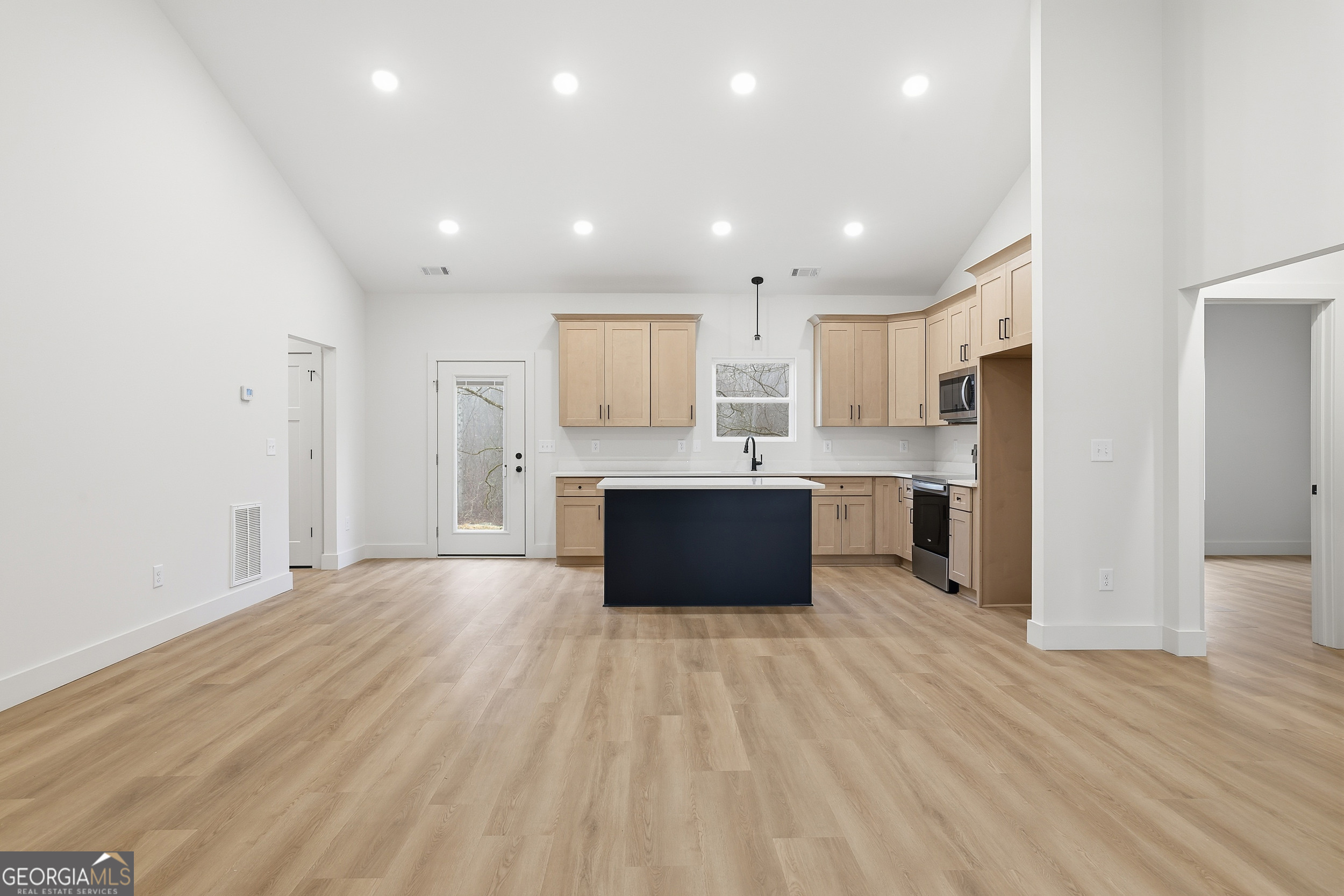 146 James Road Clarkesville, GA 30523 - Photo 6 of 25 a large kitchen with stainless steel appliances kitchen island a large counter top and a sink