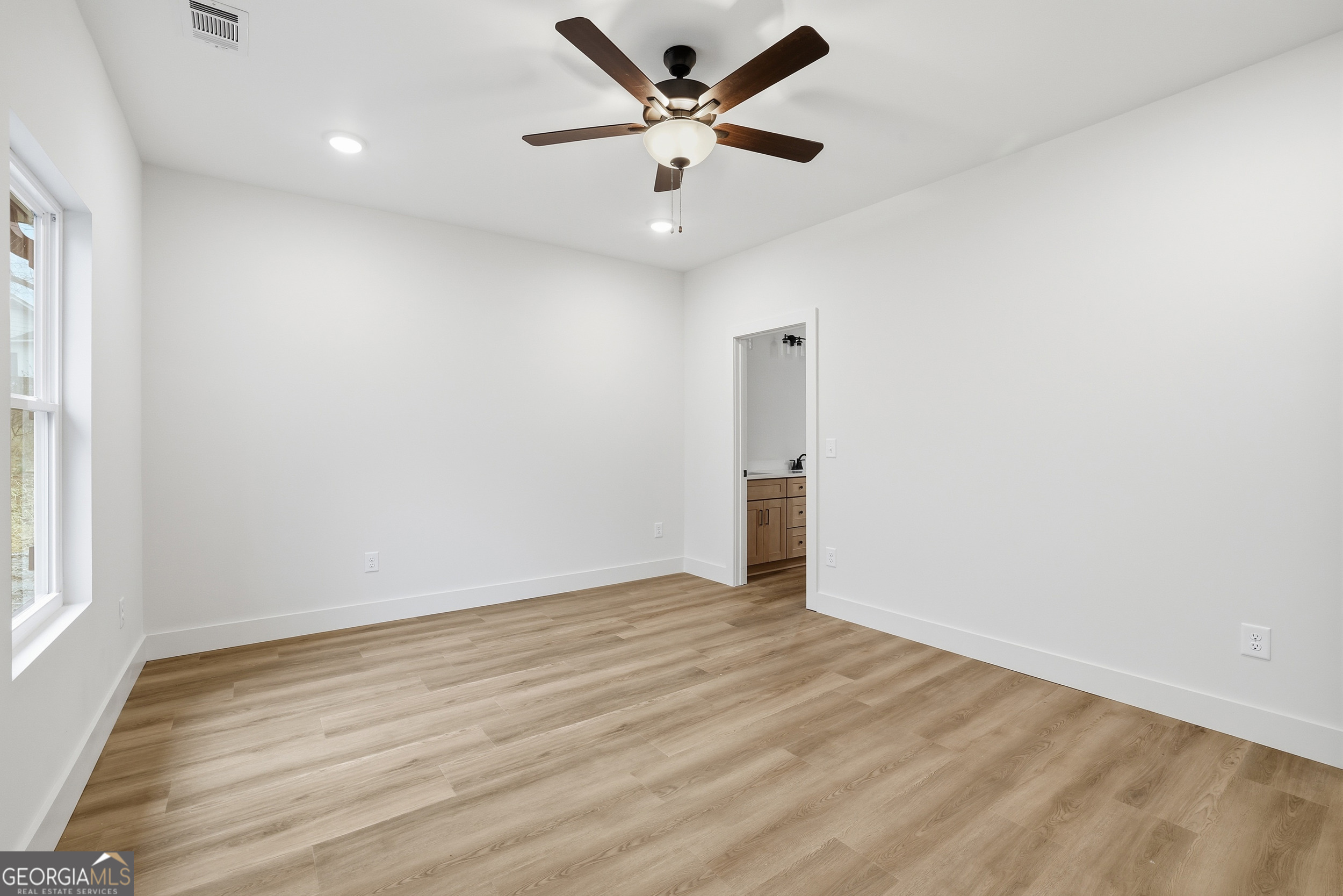 146 James Road Clarkesville, GA 30523 - Photo 9 of 25 an empty room with a window and a ceiling fan