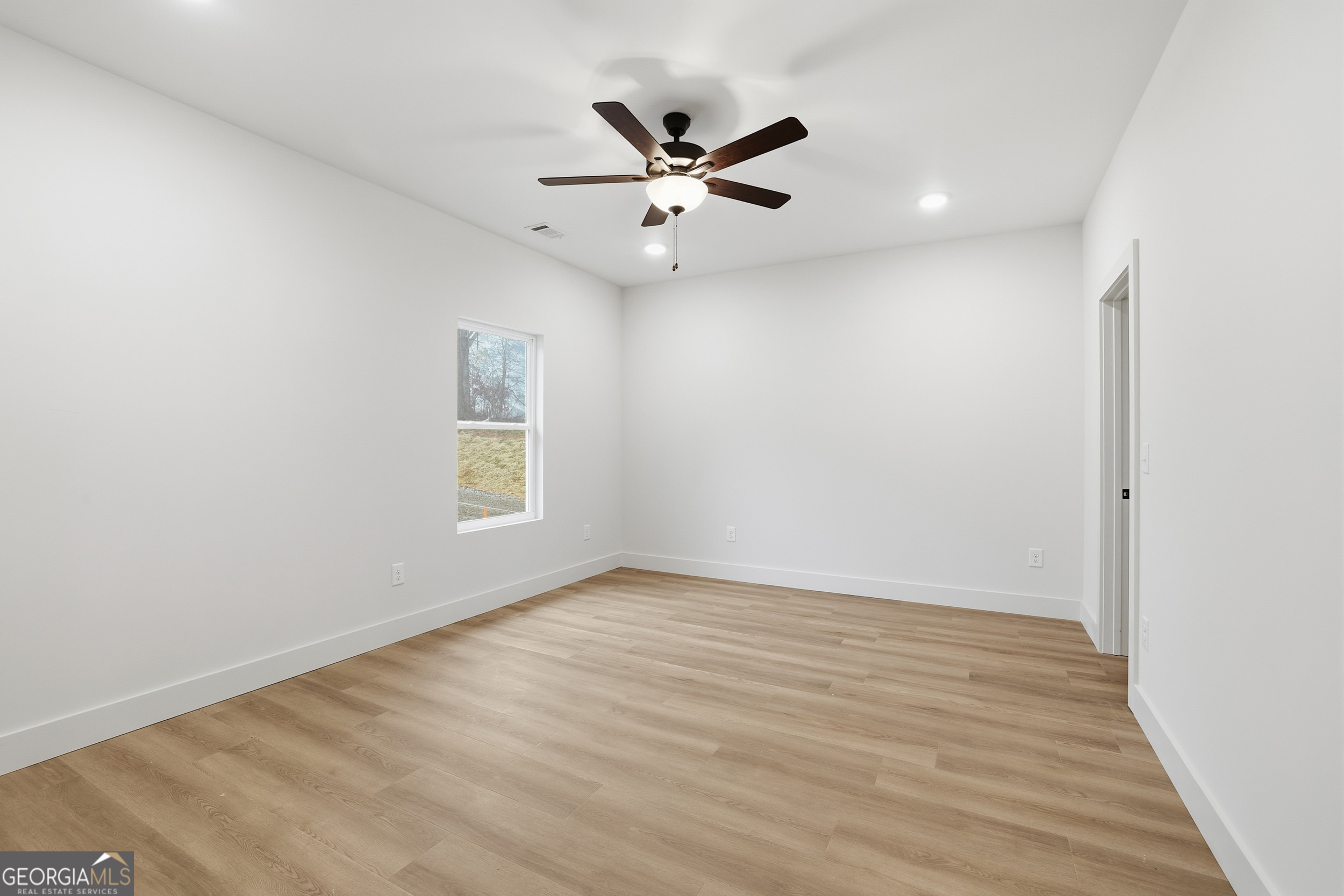 146 James Road Clarkesville, GA 30523 - Photo 10 of 25 an empty room with wooden floor and ceiling fan