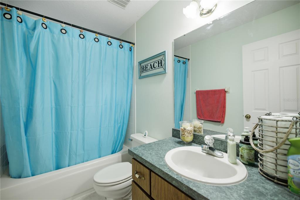 17900 Northwest 120th Avenue Road Reddick, FL 32686 - Photo 36 of 45 a bathroom with a sink a toilet and shower curtain
