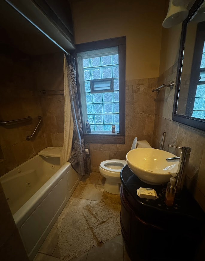 7940 South Marshfield Avenue Chicago, IL 60620 - Photo 3 of 4 a bathroom with a sink toilet and shower