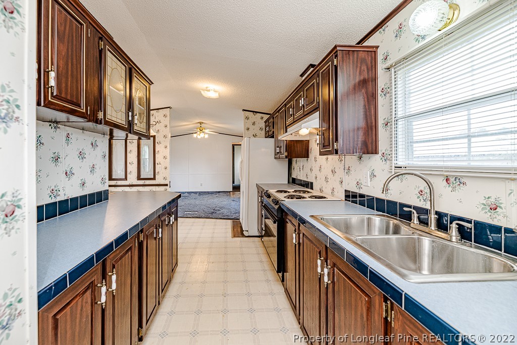 256 Union Church Road Carthage, NC 28327 - Photo 15 of 29 a kitchen with stainless steel appliances granite countertop a sink stove and cabinets