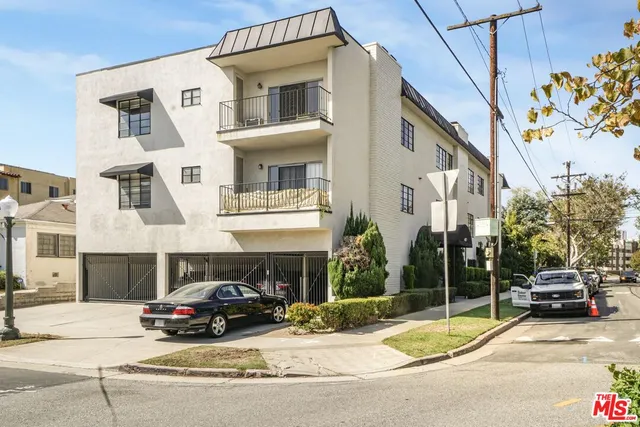 a car parked in front of a white building