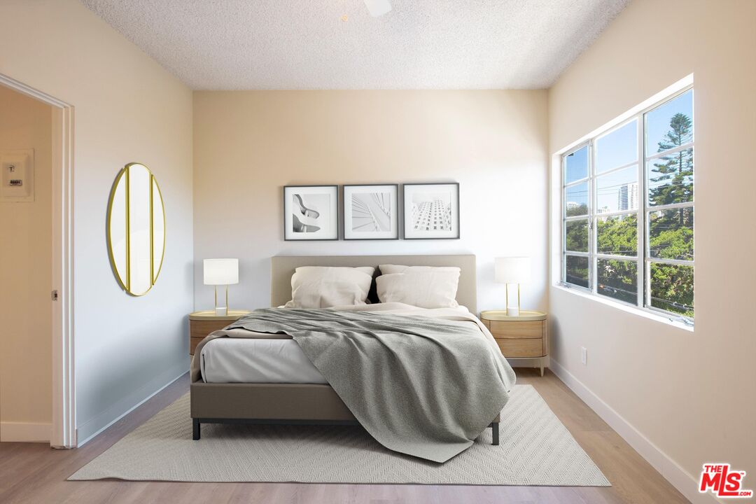 1677 Westholme Avenue Los Angeles, CA 90024 - Photo 15 of 43 a bedroom with a bed a painting and a window