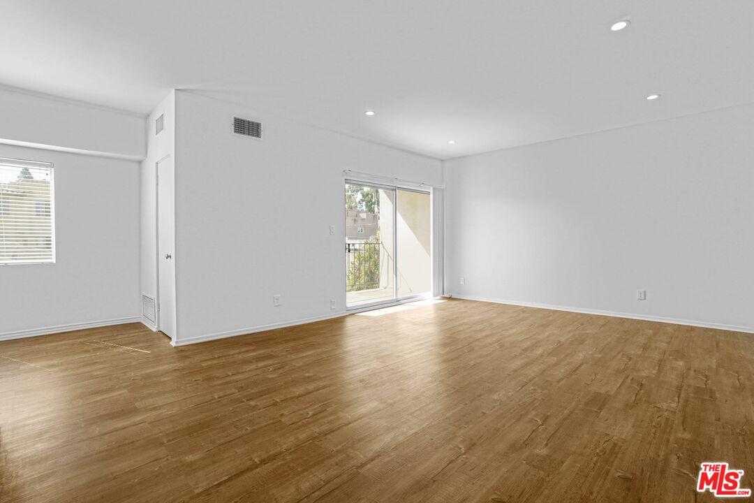 1677 Westholme Avenue Los Angeles, CA 90024 - Photo 23 of 43 a view of an empty room with wooden floor and a window