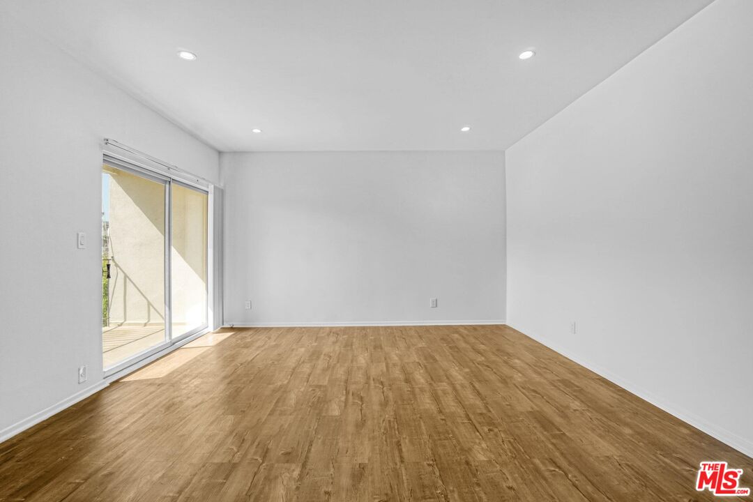 1677 Westholme Avenue Los Angeles, CA 90024 - Photo 24 of 43 a view of an empty room with wooden floor and a window