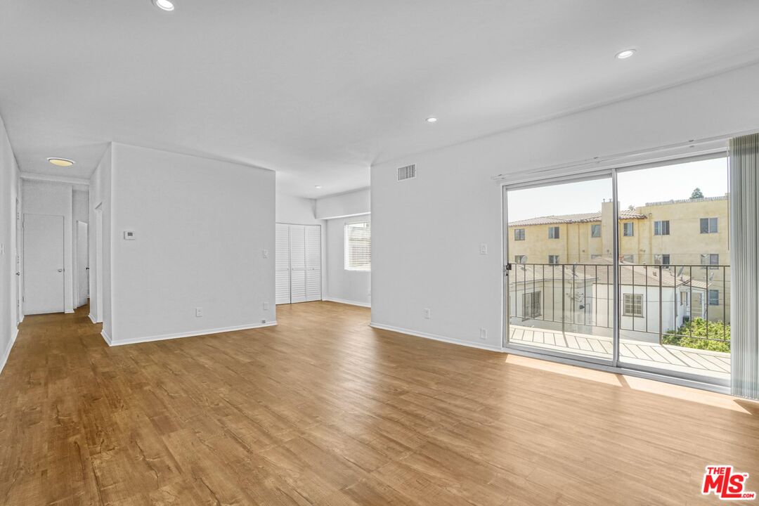 1677 Westholme Avenue Los Angeles, CA 90024 - Photo 25 of 43 a view of an empty room with wooden floor and a window