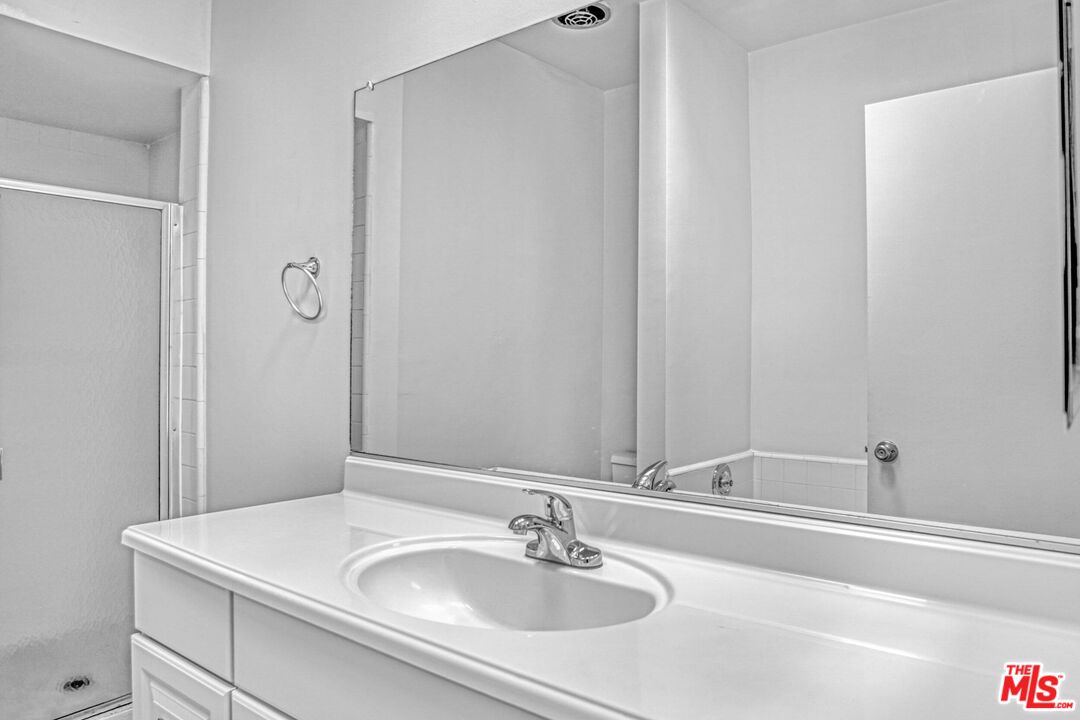 1677 Westholme Avenue Los Angeles, CA 90024 - Photo 32 of 43 a bathroom with a sink and a mirror