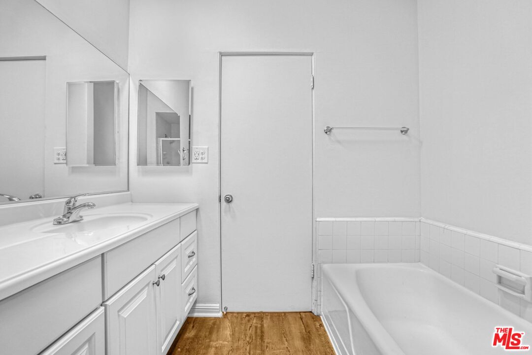1677 Westholme Avenue Los Angeles, CA 90024 - Photo 33 of 43 a bathroom with a tub sink and mirror