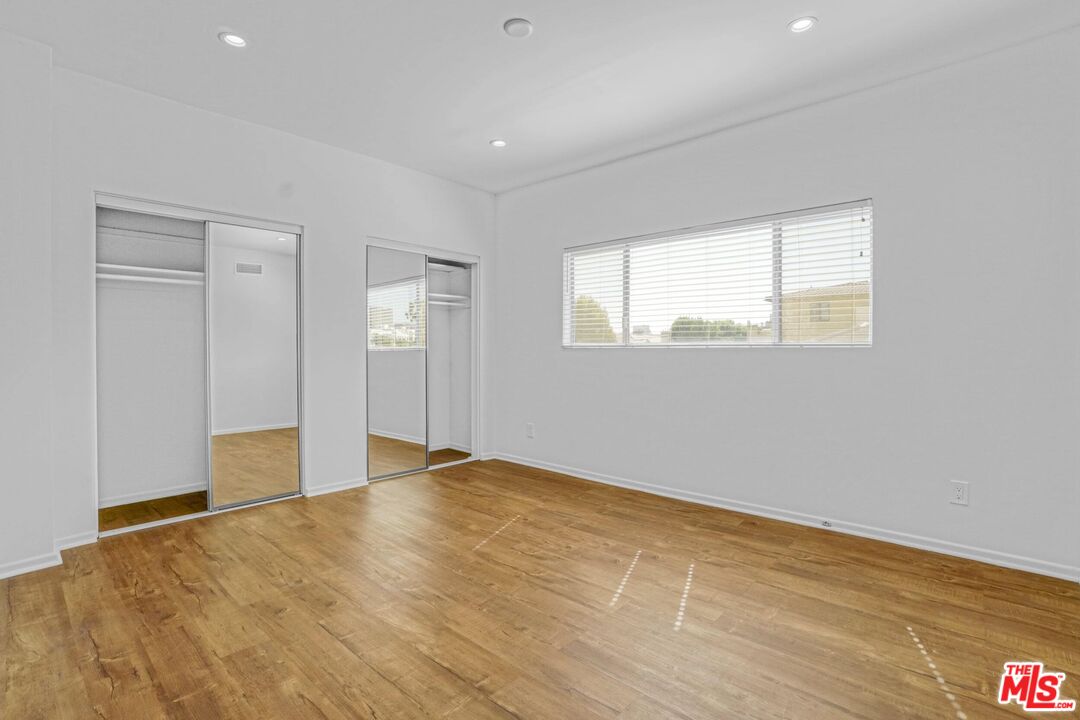 1677 Westholme Avenue Los Angeles, CA 90024 - Photo 34 of 43 an empty room with wooden floor and windows