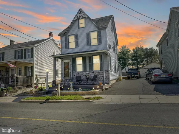 a view of a dining room with furniture and a kitchen
