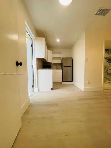 a view of a kitchen with a refrigerator