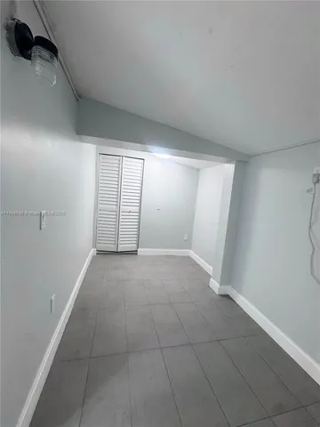 a view of an empty room and a window