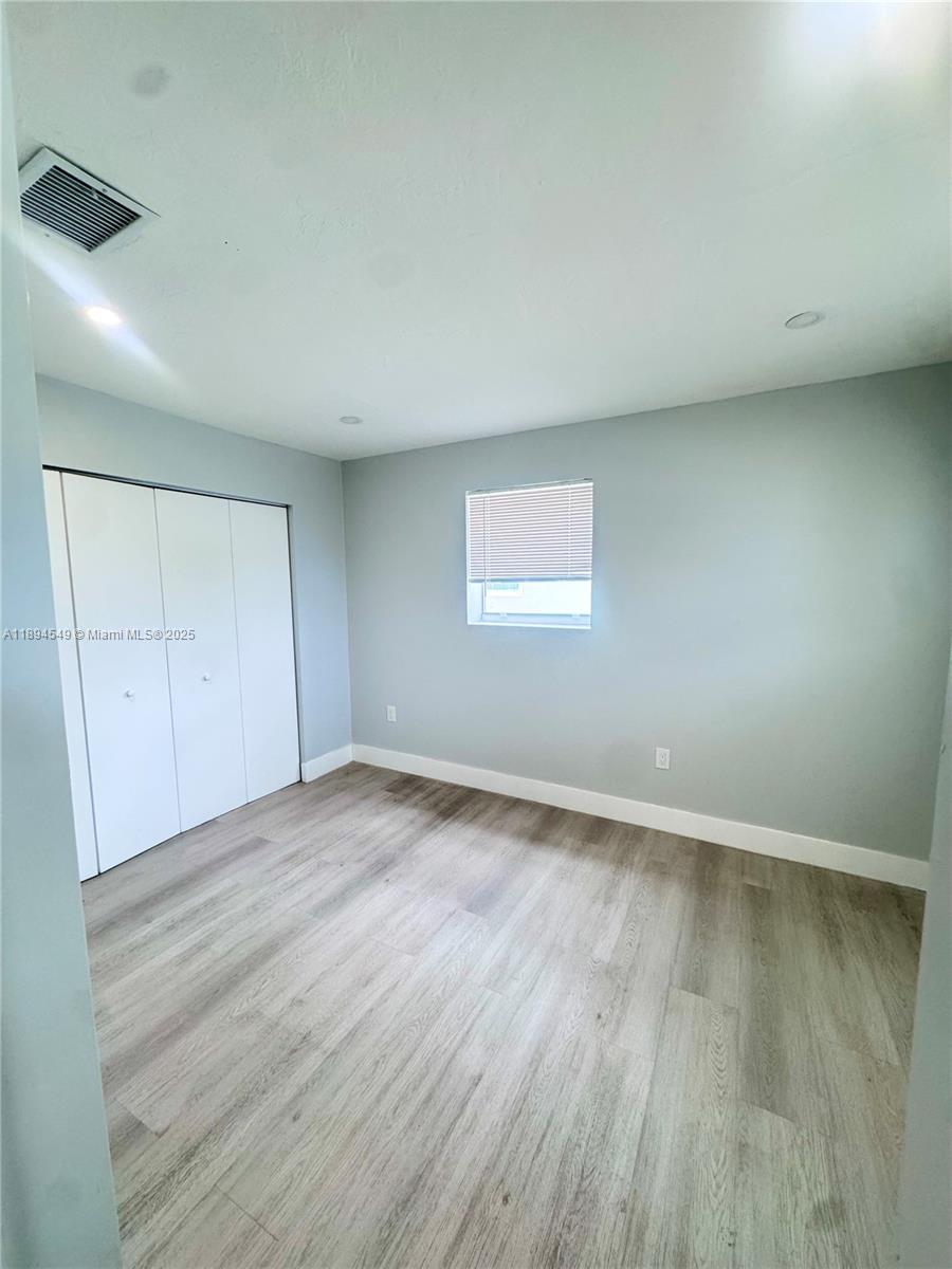 3731 Southwest 58th Terrace Davie, FL 33314 - Photo 6 of 17 an empty room with wooden floor and windows