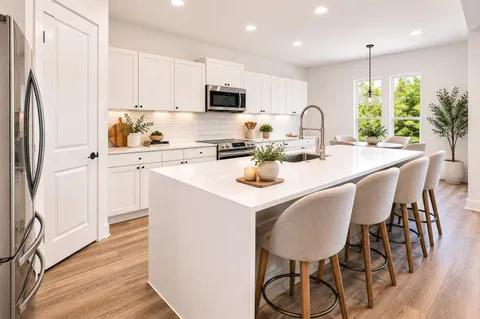 a kitchen with stainless steel appliances granite countertop a stove a sink dishwasher a refrigerator with white cabinets and wooden floor