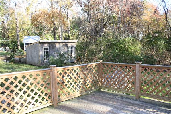 38 Richfield Road Scituate, MA 02066 - Photo 2 of 13 a wooden fence with trees in the background