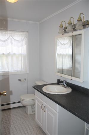 38 Richfield Road Scituate, MA 02066 - Photo 10 of 13 a bathroom with a sink and a mirror