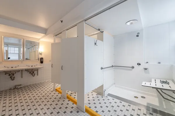 a bathroom with a sink a toilet and shower