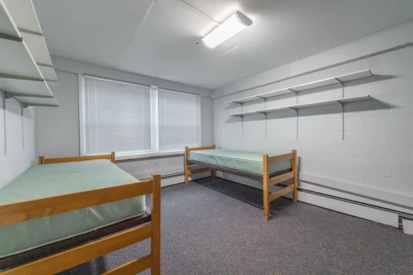 a bedroom with bunk bed and a window