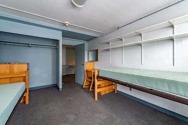 a reading room with wooden floor and furniture