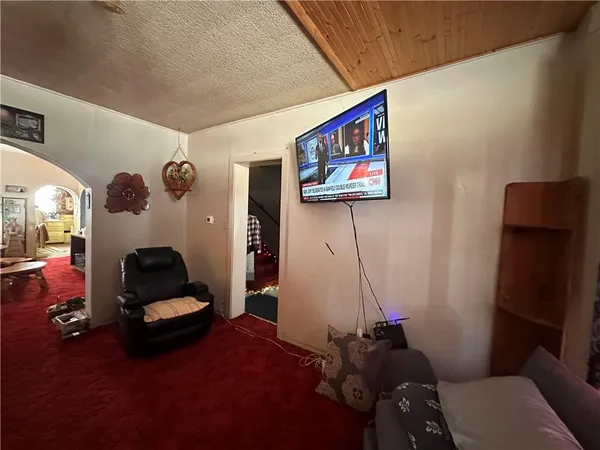 a living room with furniture and a gym equipment