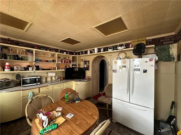 a kitchen with stainless steel appliances granite countertop a refrigerator and a stove