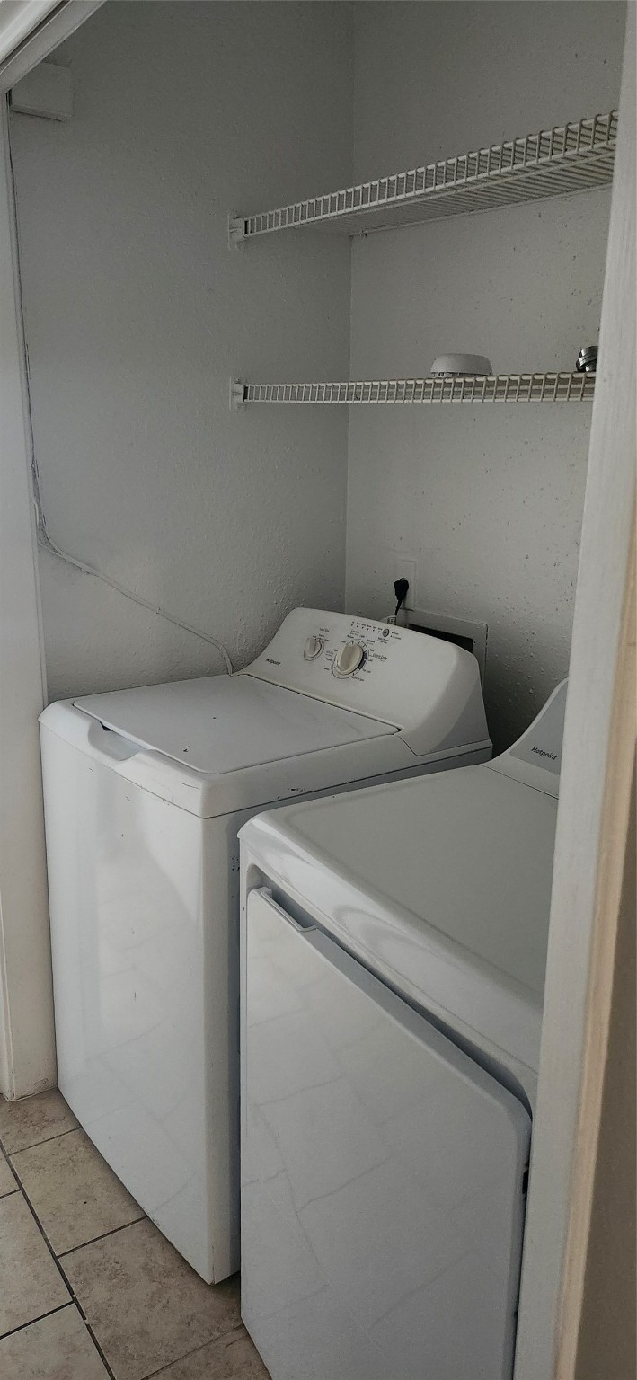 8918 Bissonnet Street, Unit 4 Houston, TX 77074 - Photo 8 of 8 a utility room with dryer and washer