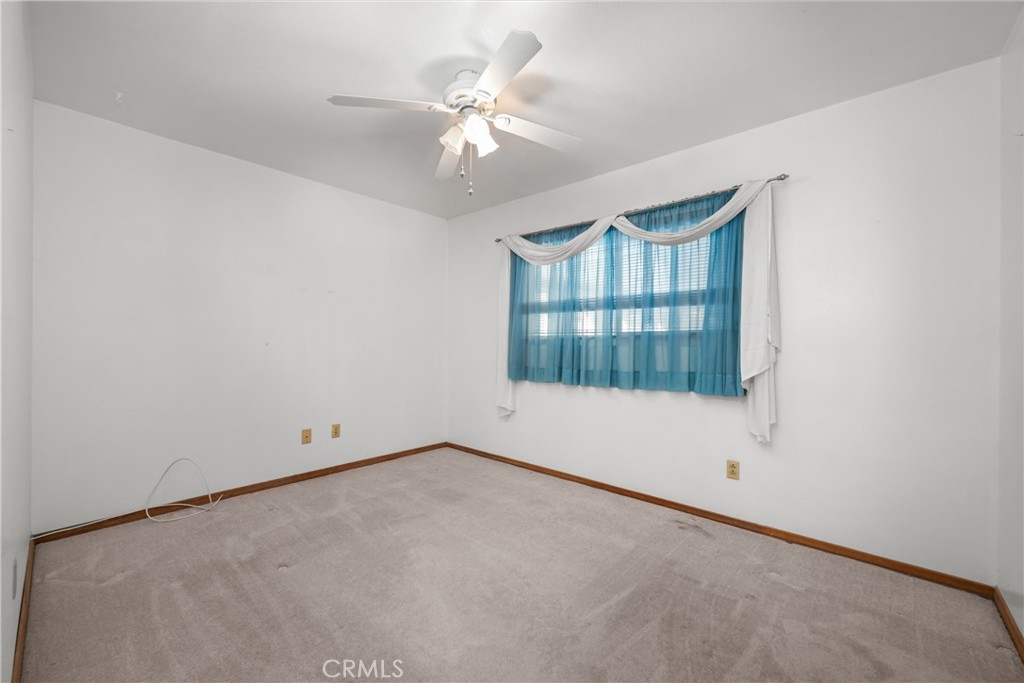 9152 Lakeview Road Lakeside, CA 92040 - Photo 12 of 32 an empty room with chandelier fan and windows