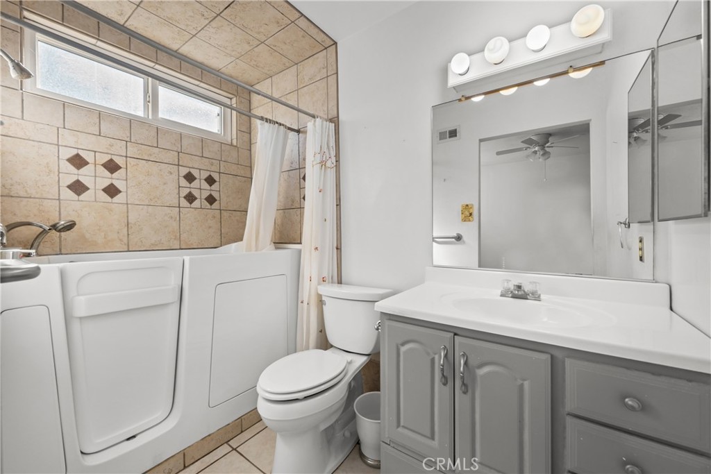 9152 Lakeview Road Lakeside, CA 92040 - Photo 19 of 32 a bathroom with a sink a toilet a mirror and shower