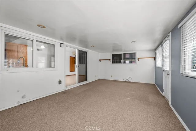 an empty room with an empty space and windows