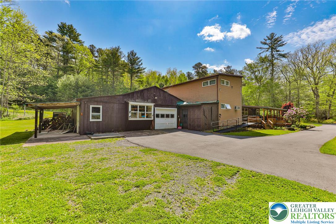 331 Cranberry Creek Road Cresco, PA 18326 - Photo 72 of 95 Discover a charming two-story home, nestled among lush trees, offering a blend of rustic appeal and tranquil surroundings.