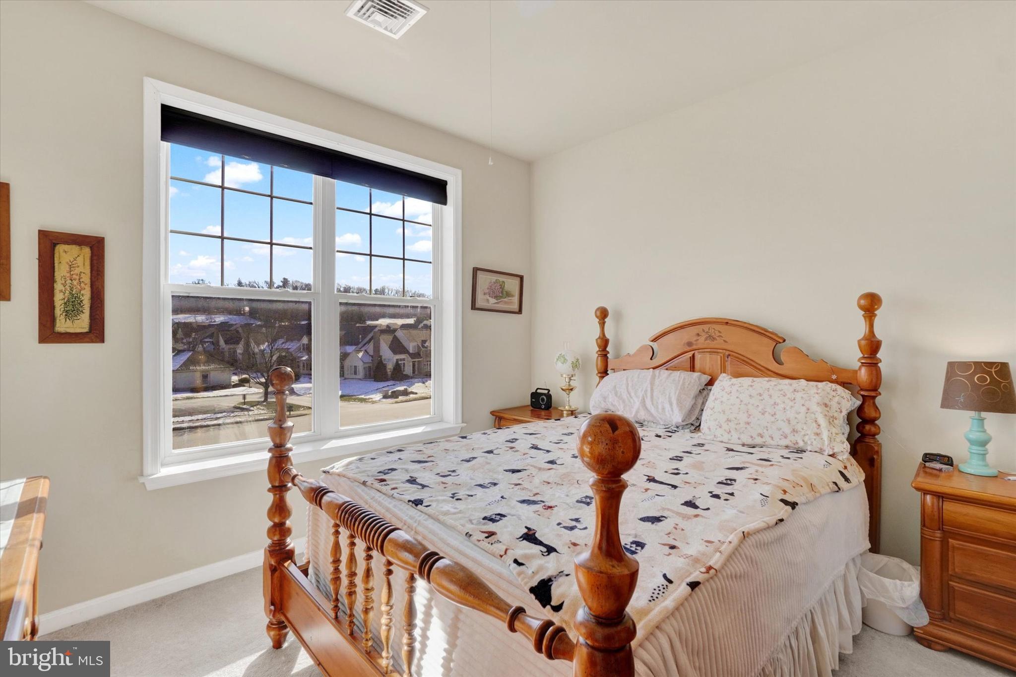 1010 Crest Way, Unit 304 York, PA 17403 - Photo 13 of 22 a bedroom with a bed and a large window