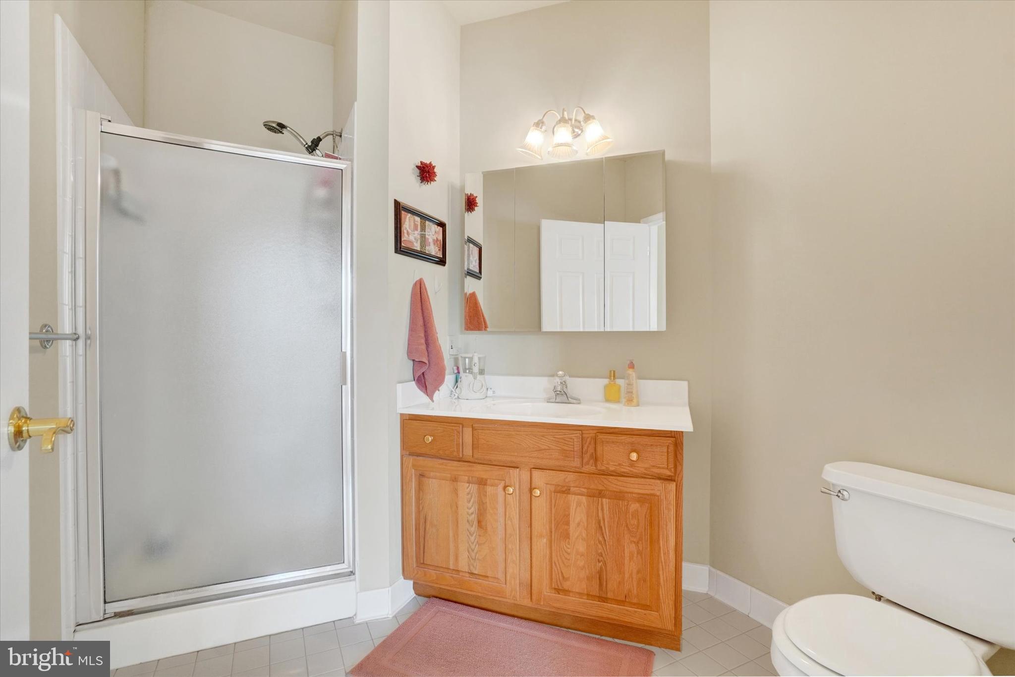 1010 Crest Way, Unit 304 York, PA 17403 - Photo 16 of 22 a bathroom with a granite countertop sink toilet and shower