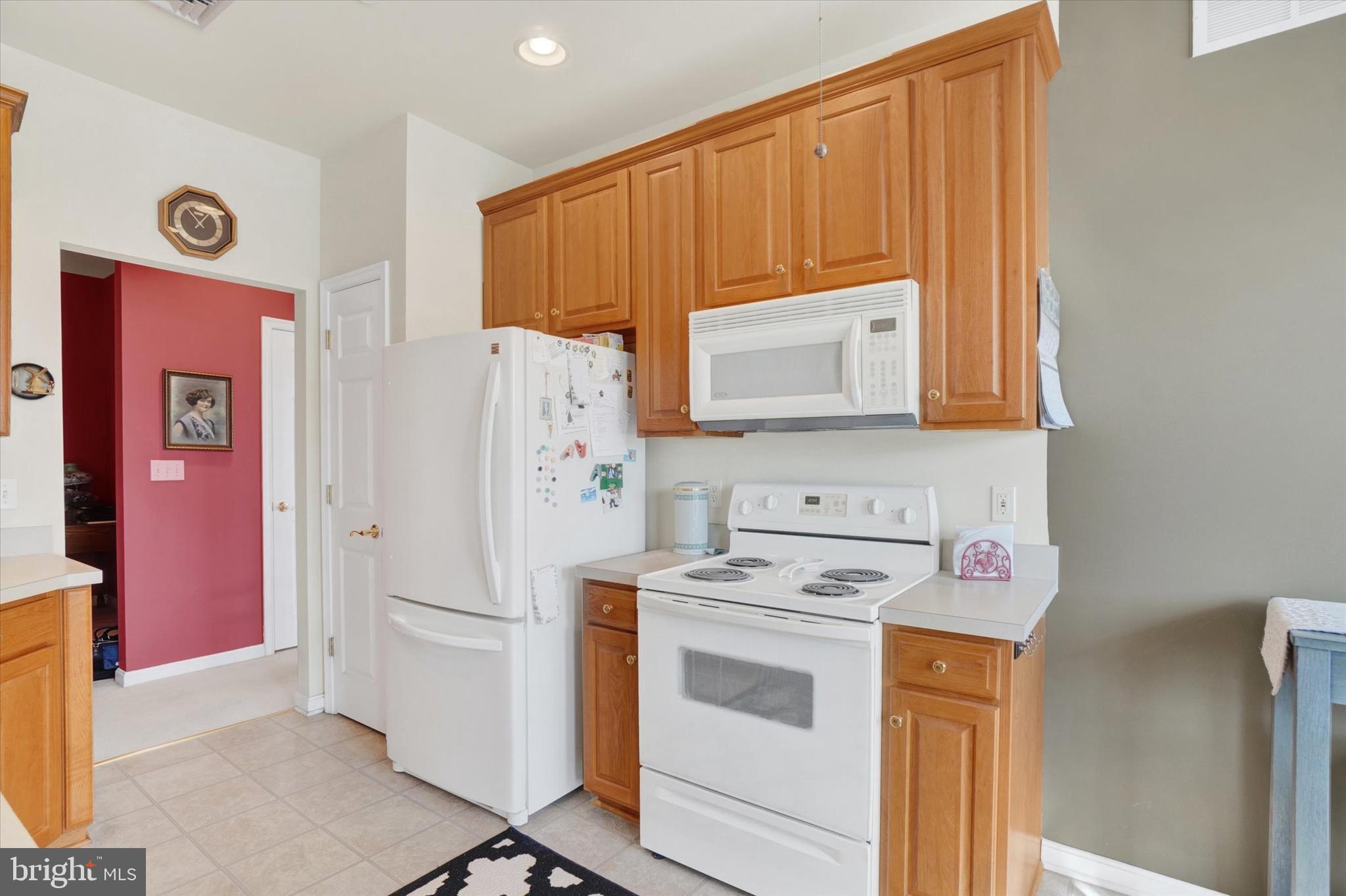 1010 Crest Way, Unit 304 York, PA 17403 - Photo 7 of 22 a view of a kitchen with fridge and wooden floor