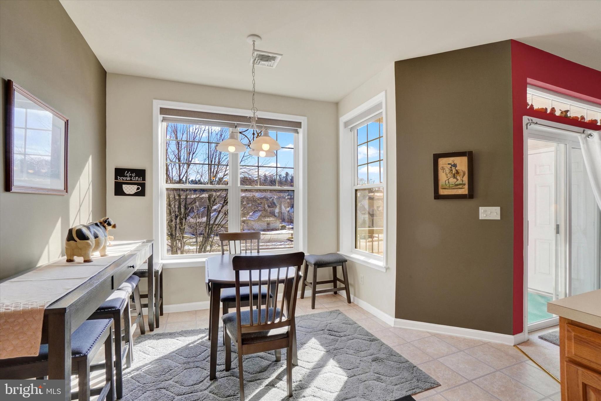 1010 Crest Way, Unit 304 York, PA 17403 - Photo 8 of 22 a view of a dining room with furniture window and outside view