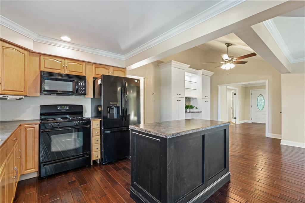 Wonderful Kitchen with Hardwood and Island Open to Dining Area with Ceiling Fan and Foyer