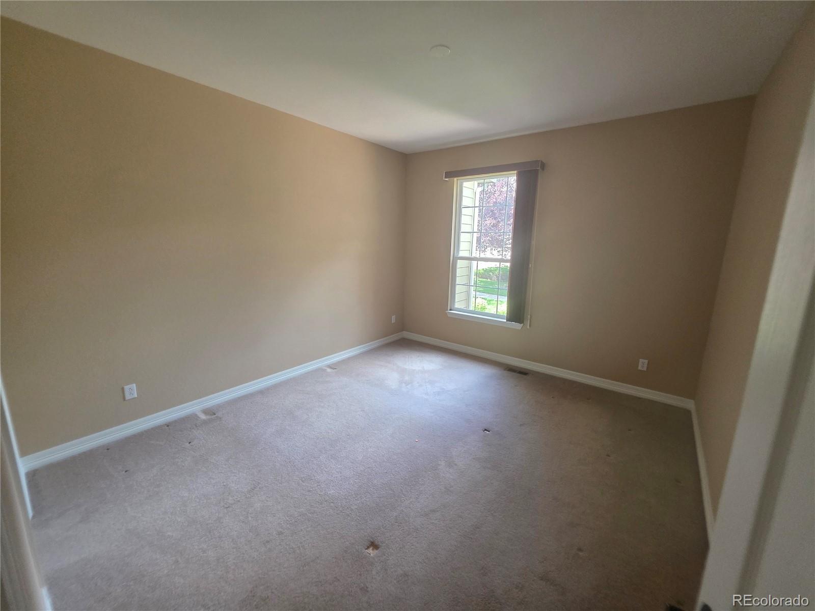 8911 Tappy Toorie Place Highlands Ranch, CO 80129 - Photo 18 of 28 an empty room with windows