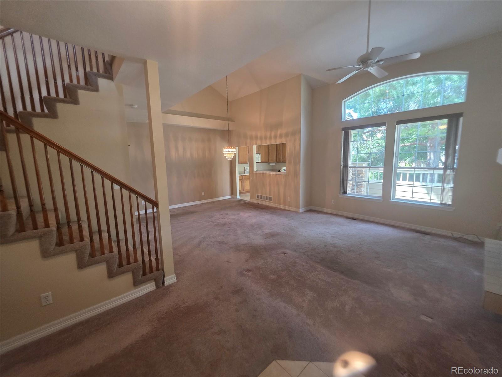 8911 Tappy Toorie Place Highlands Ranch, CO 80129 - Photo 2 of 28 a view of a hallway with staircase